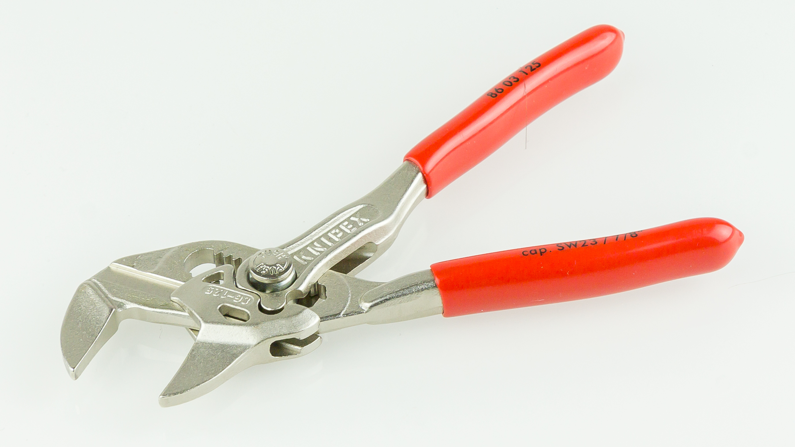KNIPEX 86 03 125 with open smooth jaws, visible adjustment mechanism and SW23 capacity marking.