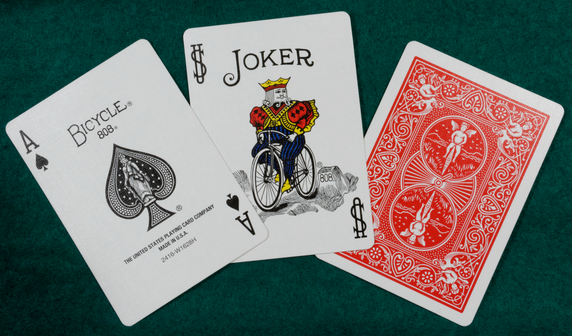 Bicycle Standard 808 ace of spades and Joker beside a red Rider Back card, showing the normal corner index and textured surface.