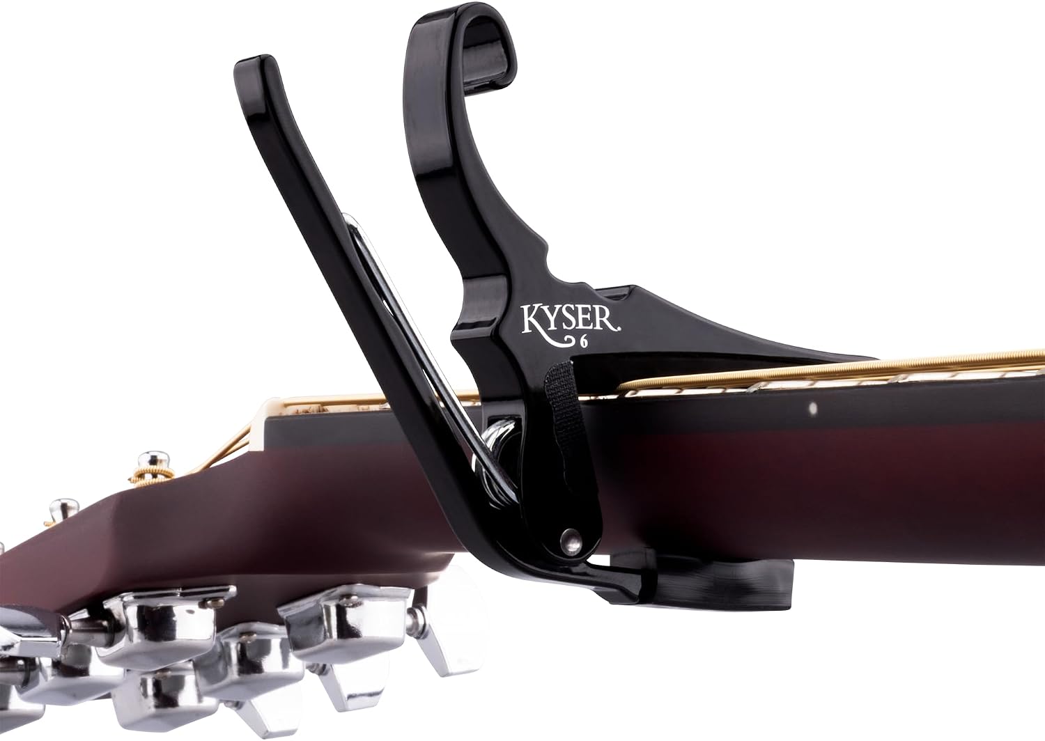 Matching black Kyser 6 capo mounted across an acoustic-guitar neck, showing the string bar and rear padded contact