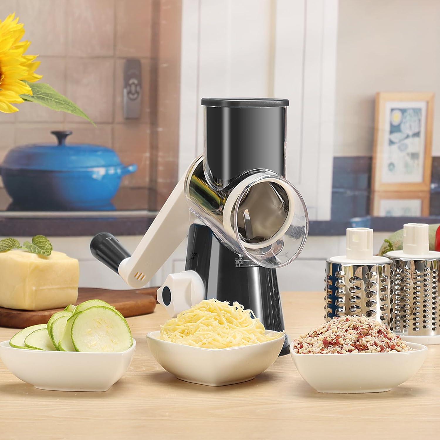 Black Cambom 315D grater on a kitchen counter with sliced zucchini, shredded cheese and coarse vegetable pieces