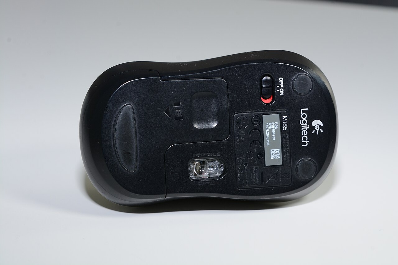 Underside of a Logitech M185 showing its power switch, optical sensor and closed battery cover