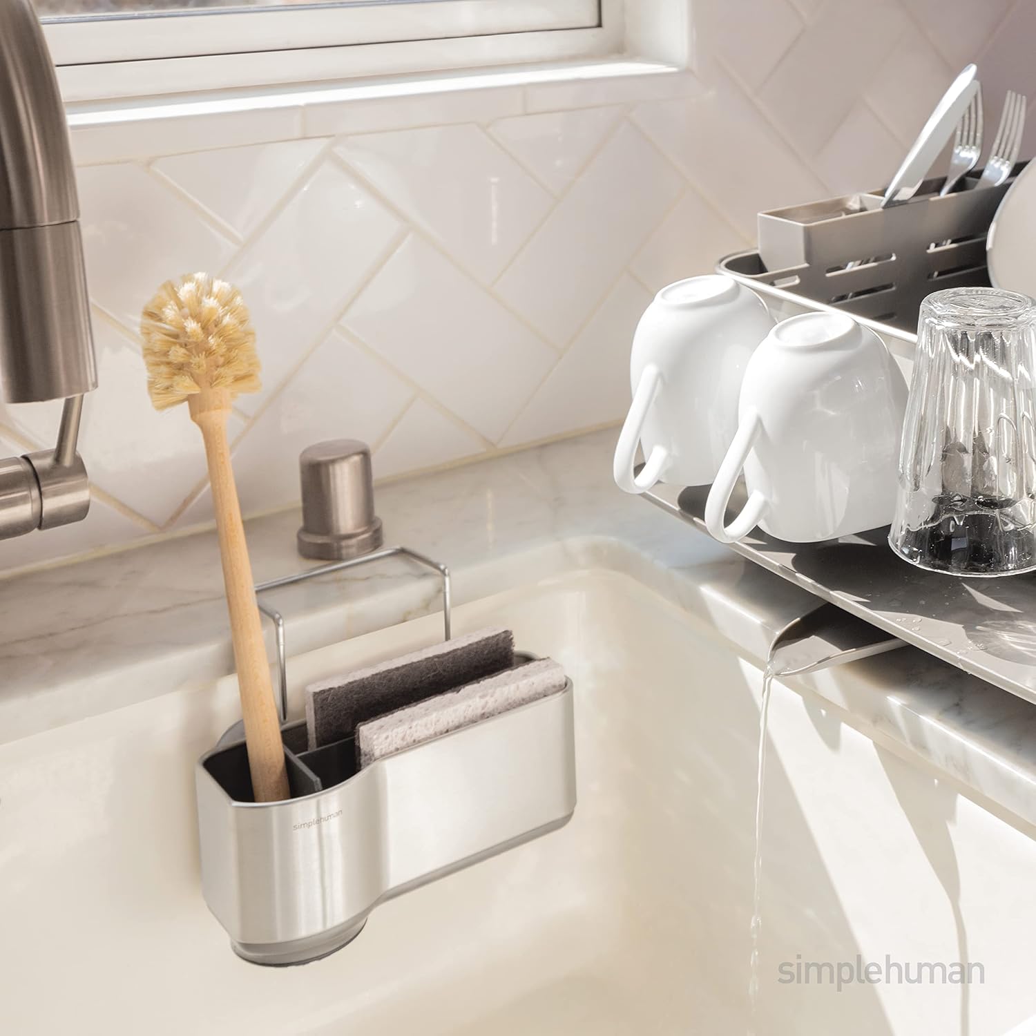 simplehuman KT1116 sink caddy mounted inside a kitchen sink with a long brush and sponges