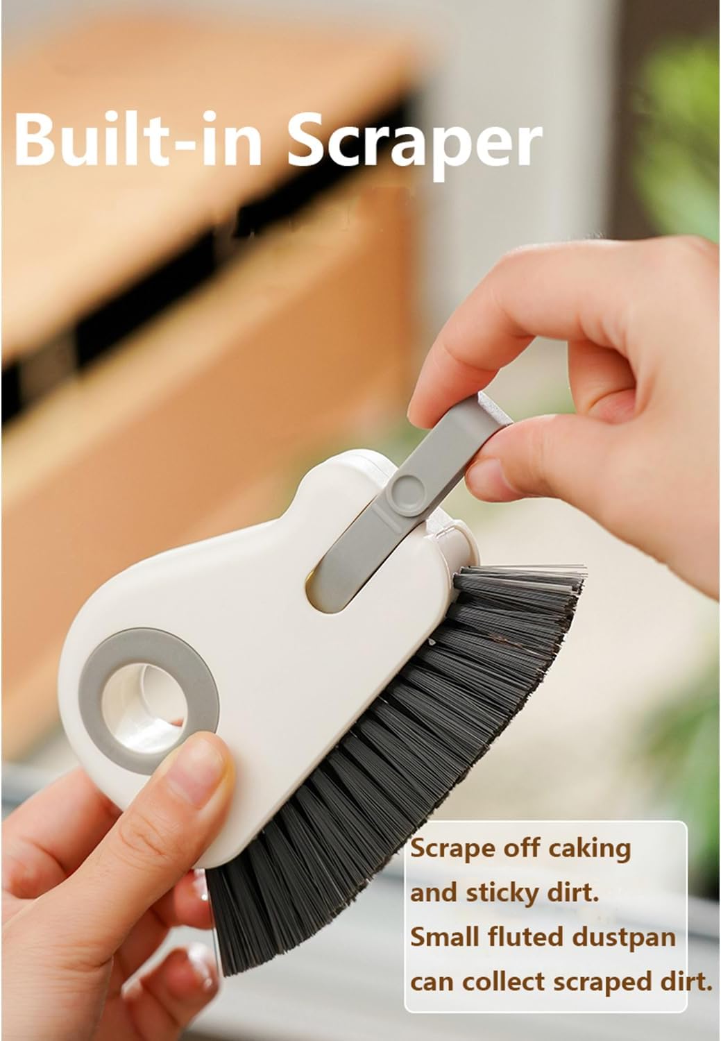 Gray scraper removed from its storage slot in the white ESUOHYM brush
