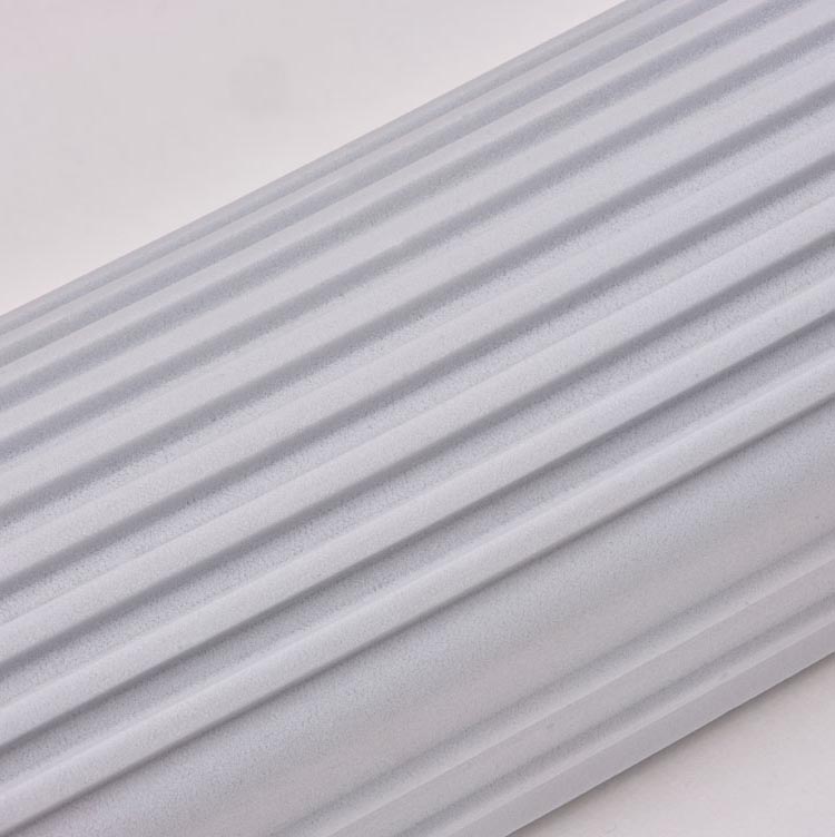 Close view of dust held in the ridges of a gray Scrub Daddy Damp Duster