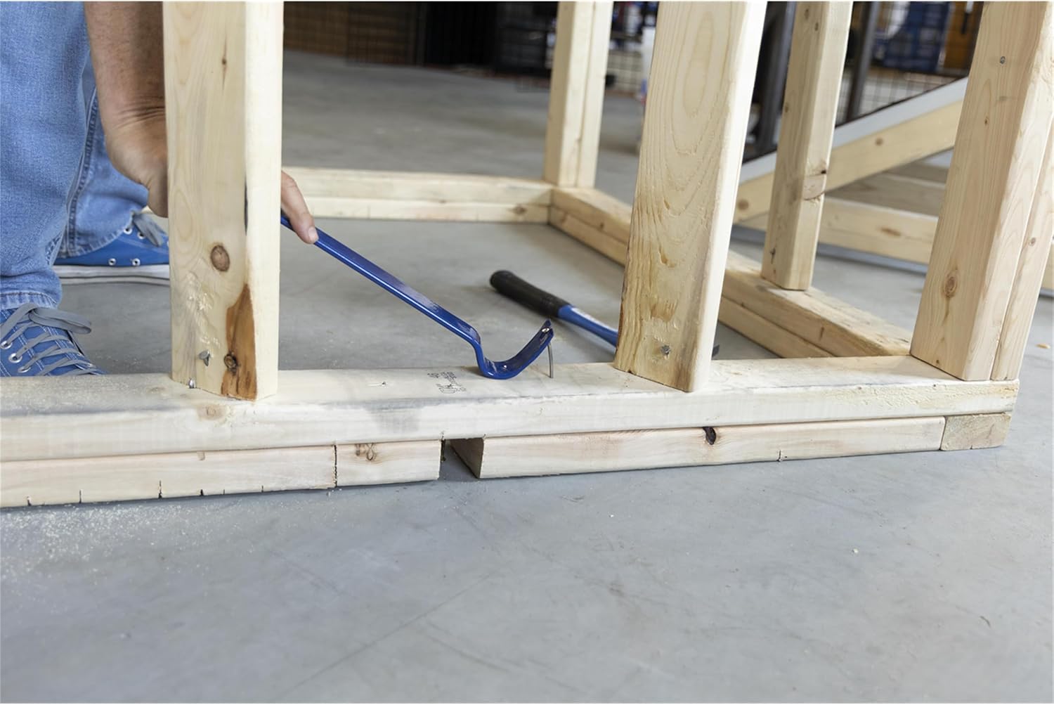 Curved SuperBar end engaging a protruding nail in a wooden frame