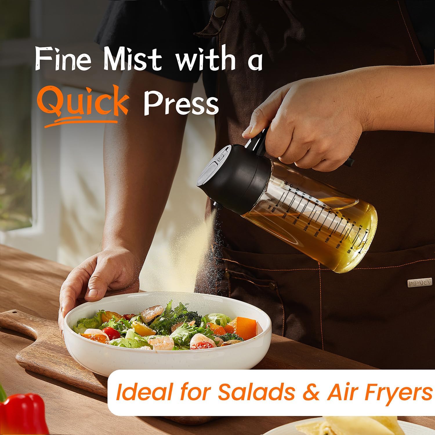 Hand operating black TrendPlain sprayer over a salad
