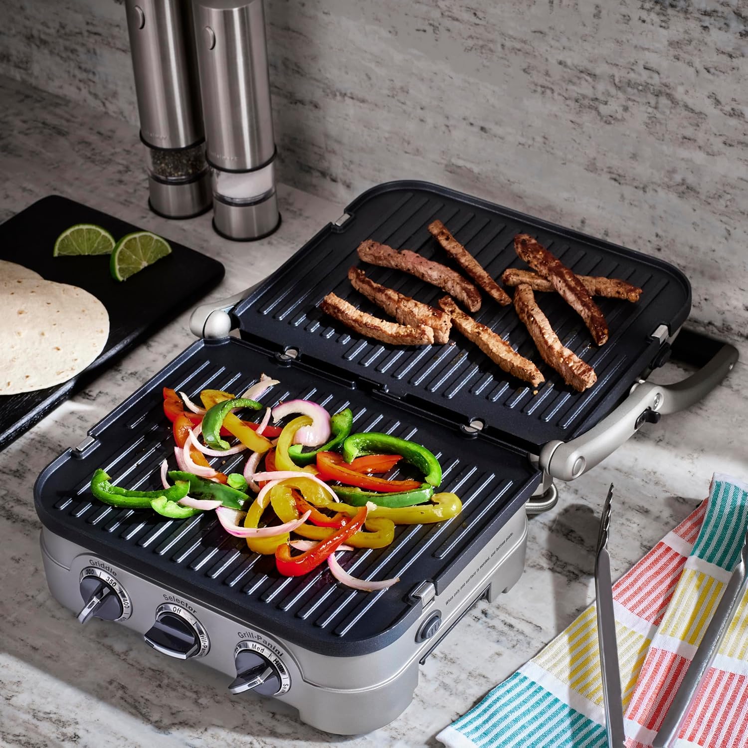 Cuisinart GR-4NNAS opened flat with meat strips on one plate and peppers and onions on the other