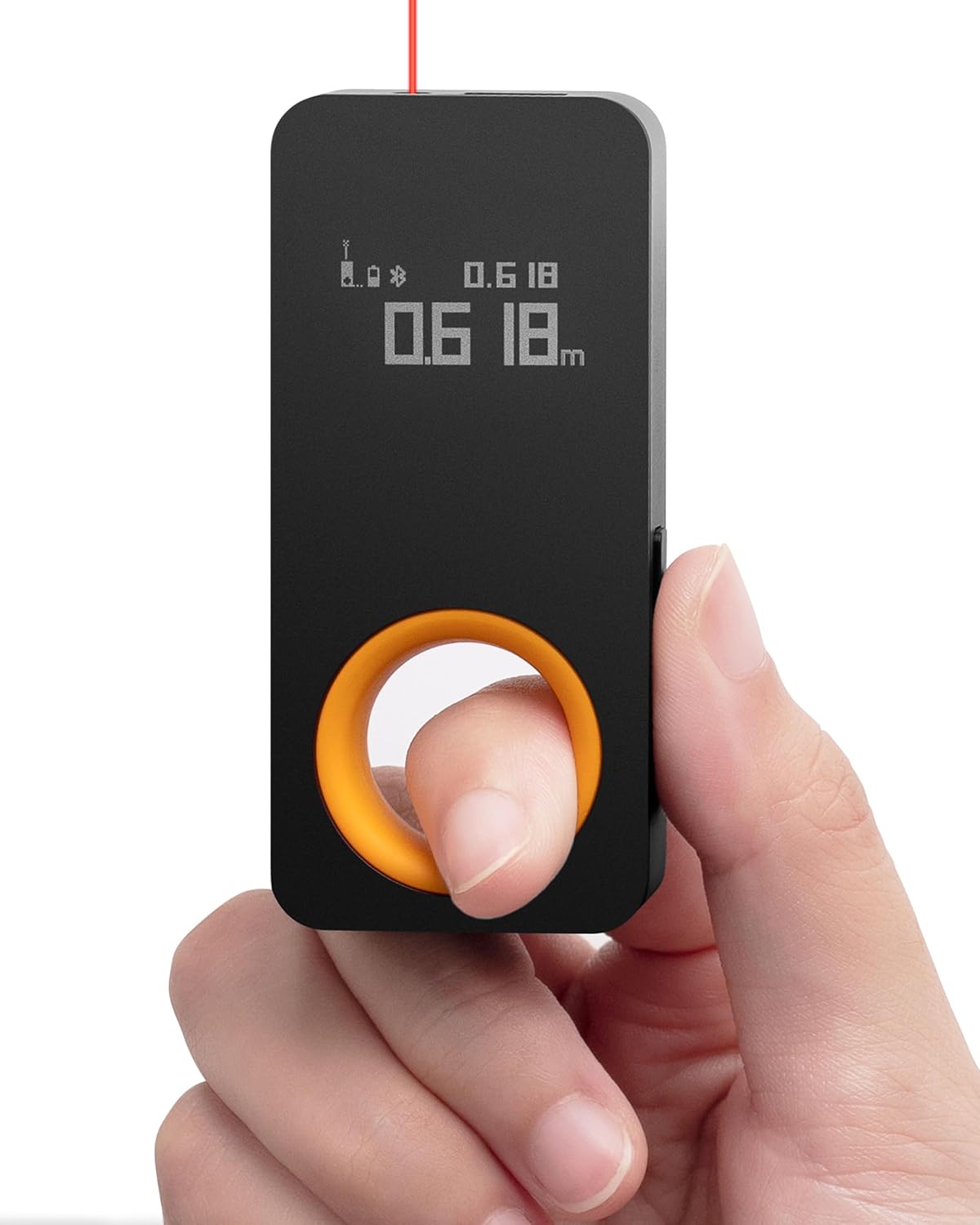 Black HOTO QWCJY001 laser measure held in a hand with its display and round orange-rimmed opening visible