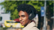 Person wearing black Sony WH-CH720N headphones outdoors, official Sony lifestyle image