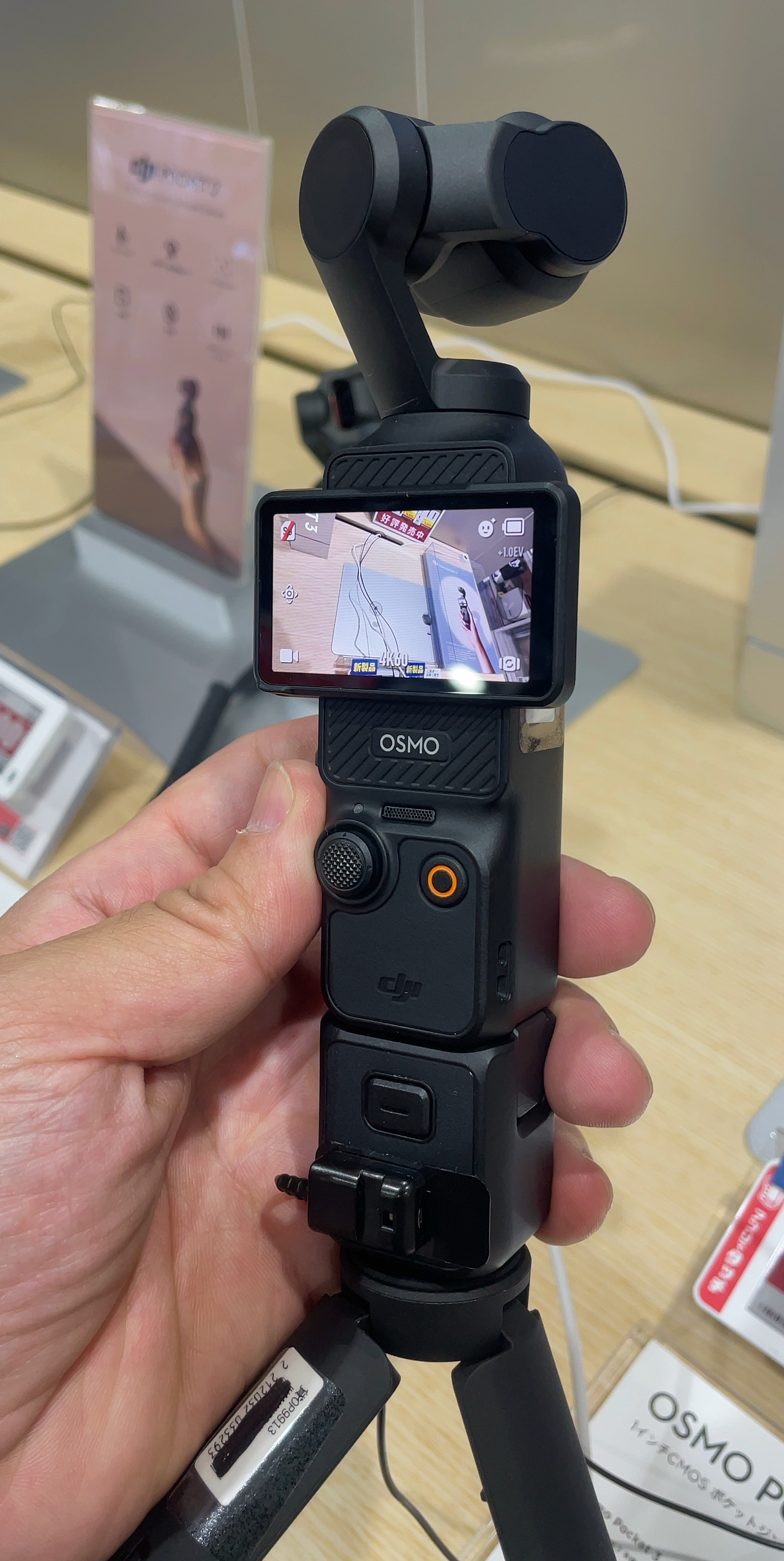 Black DJI Osmo Pocket 3 with its two-inch touchscreen rotated horizontally