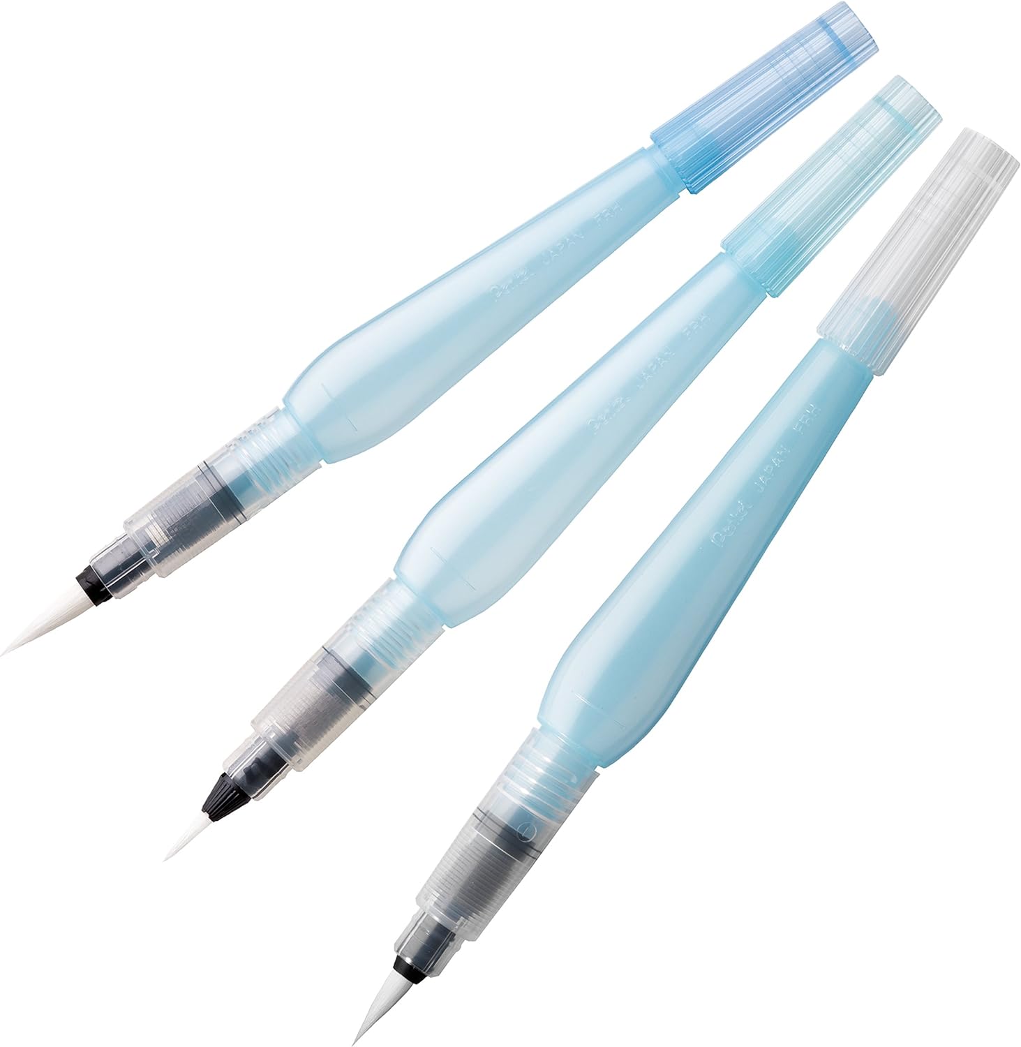 Three uncapped Pentel Aquash brushes showing pointed nylon tips and translucent refillable barrels