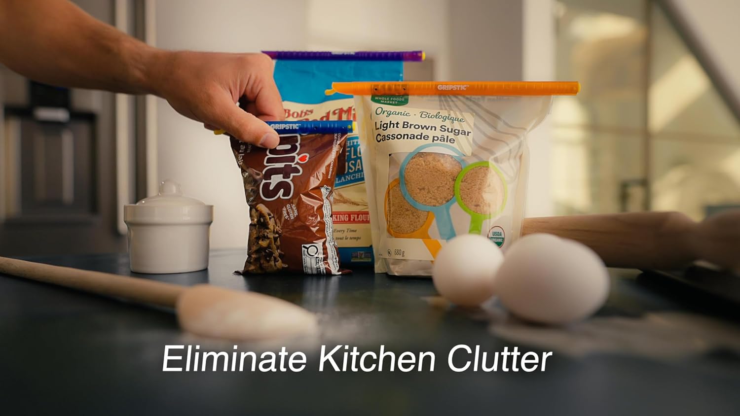 Blue, purple and orange GripStic rods sealing several food bags on a kitchen counter.