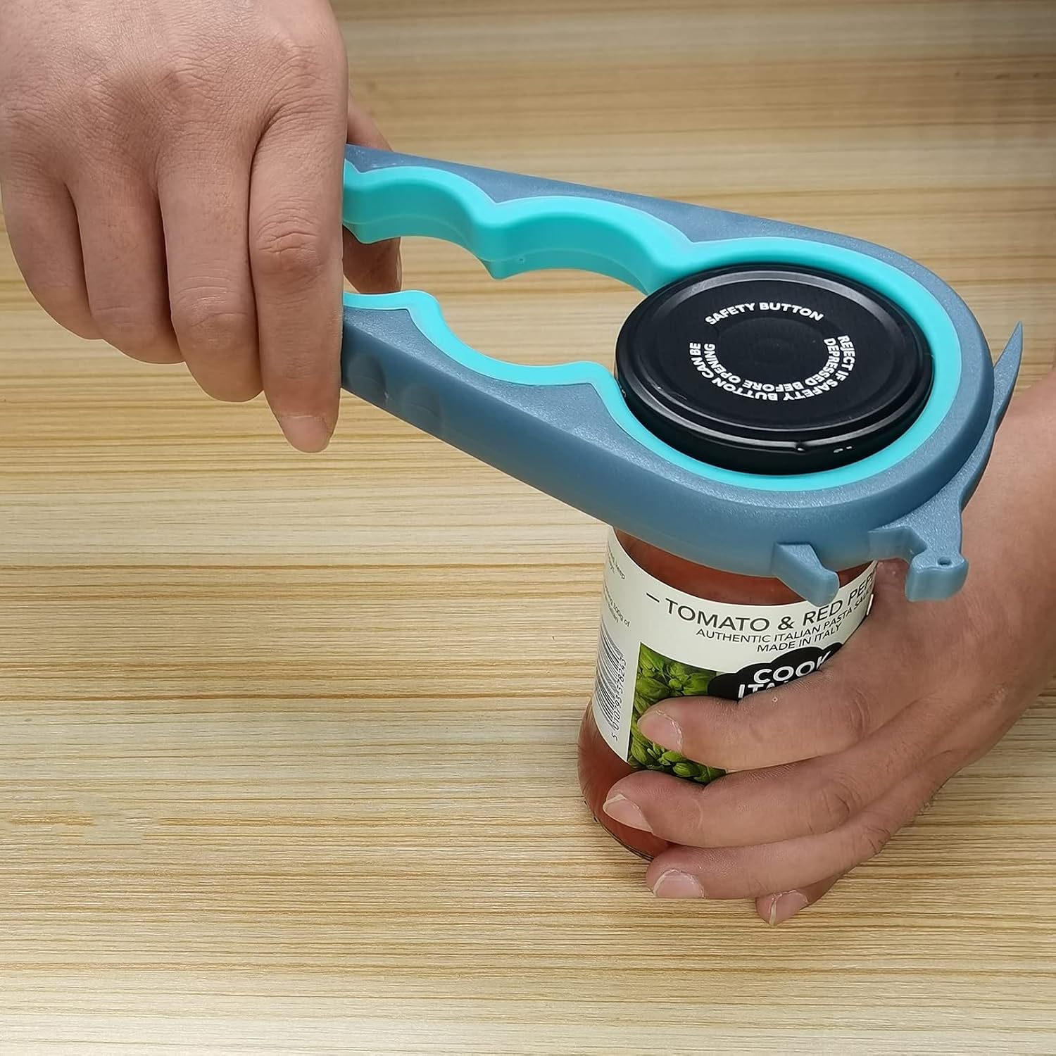 One hand gripping an Otstar opener while the other steadies a jar