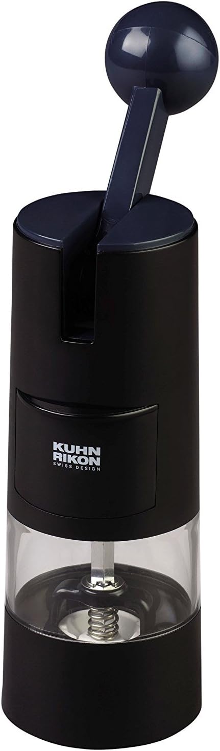 白色背景上的黑色 Kuhn Rikon 棘轮研磨器，带球形握柄拉杆、前侧加料门和透明储料仓。