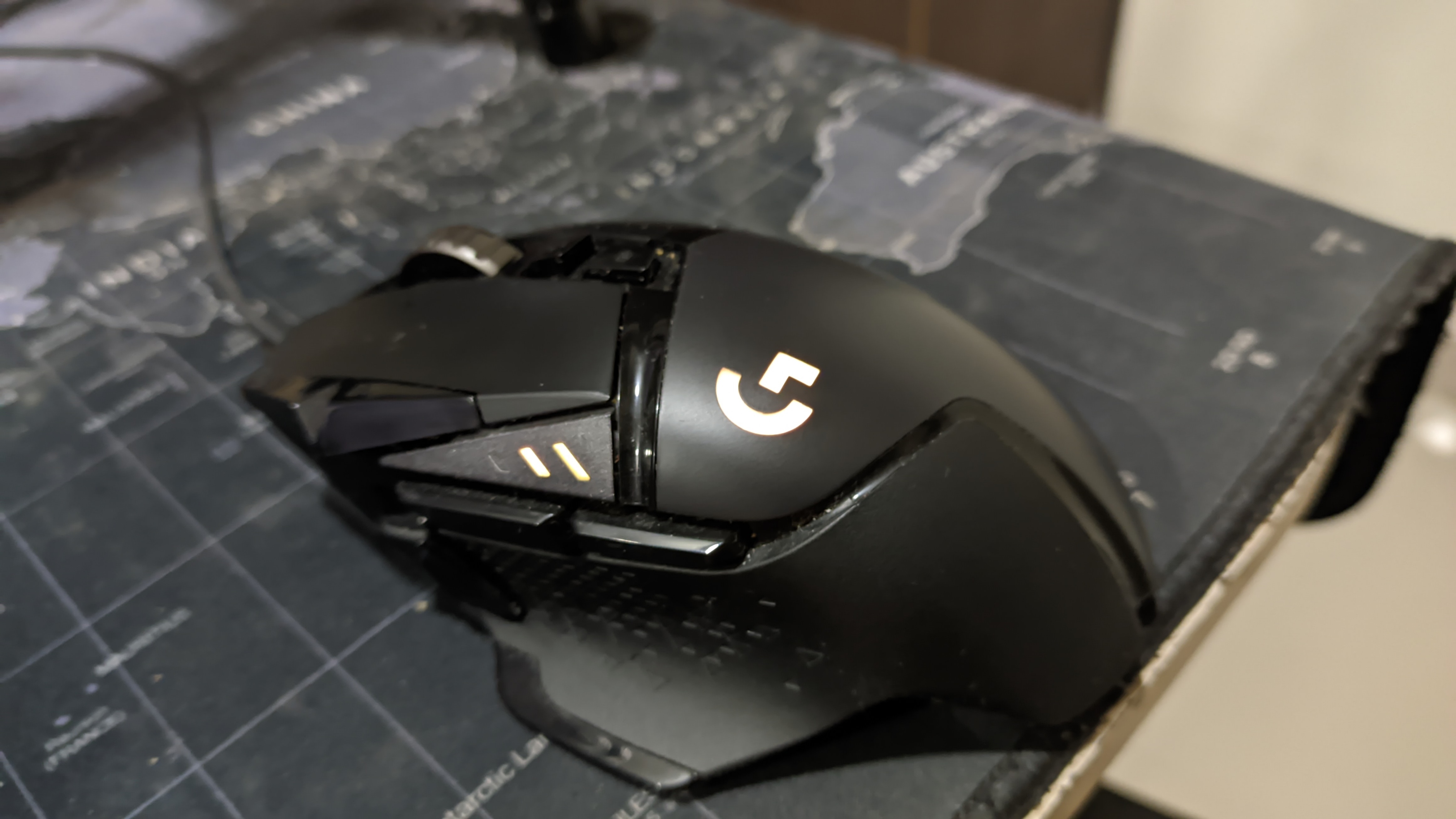 Black wired Logitech G502 HERO showing its sculpted body and thumb-side controls.