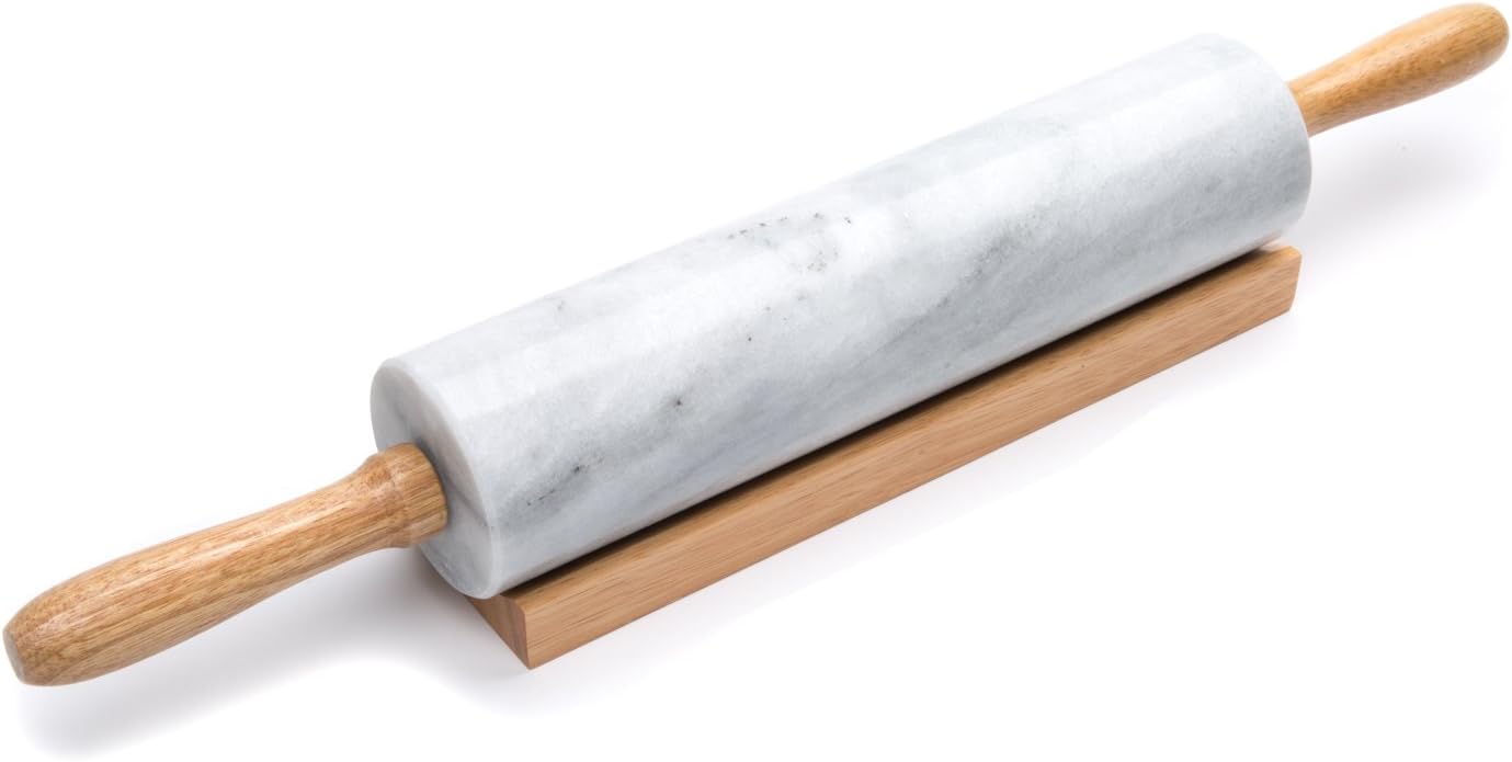 Fox Run white marble rolling pin with wooden handles resting in a wooden cradle