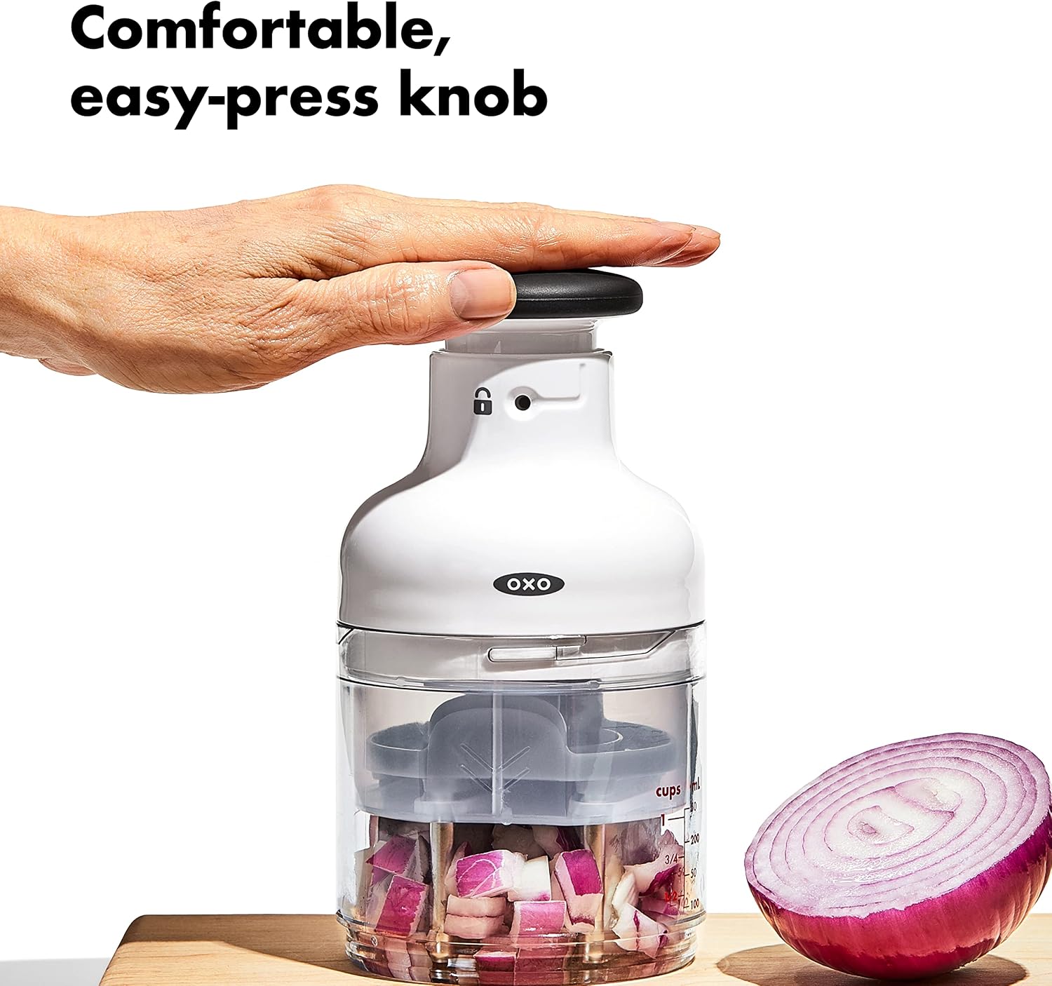 OXO chopper pressed above onion pieces inside its marked cup