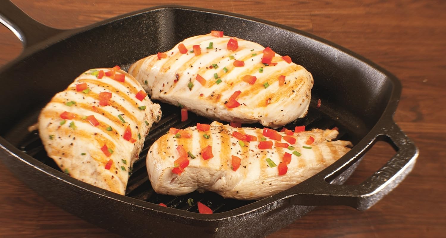 Chicken pieces with grill stripes displayed in the Lodge ridged pan.