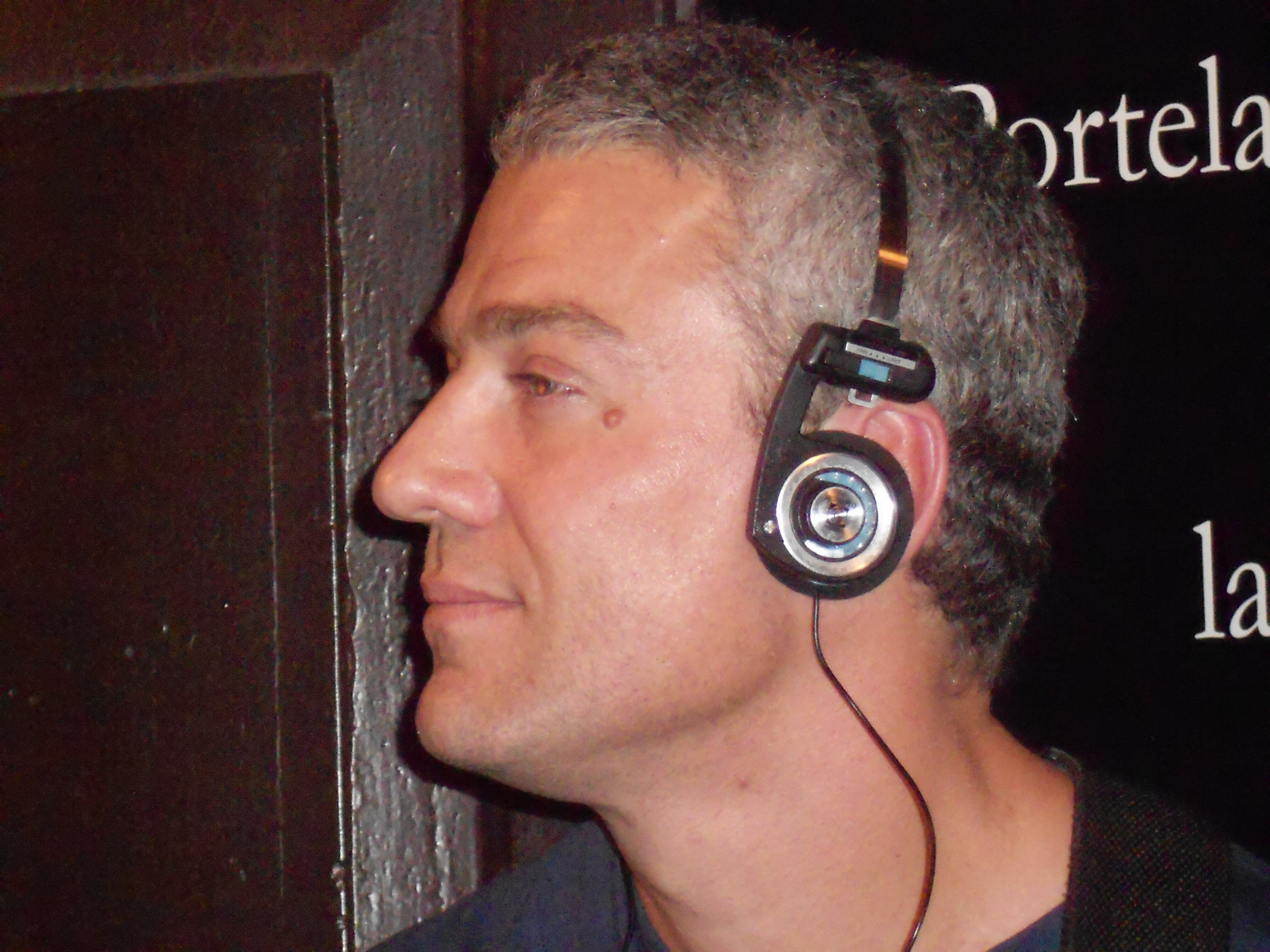 Historical side view of classic wired Koss Porta Pro headphones showing the ear cushion and upper pad when worn.