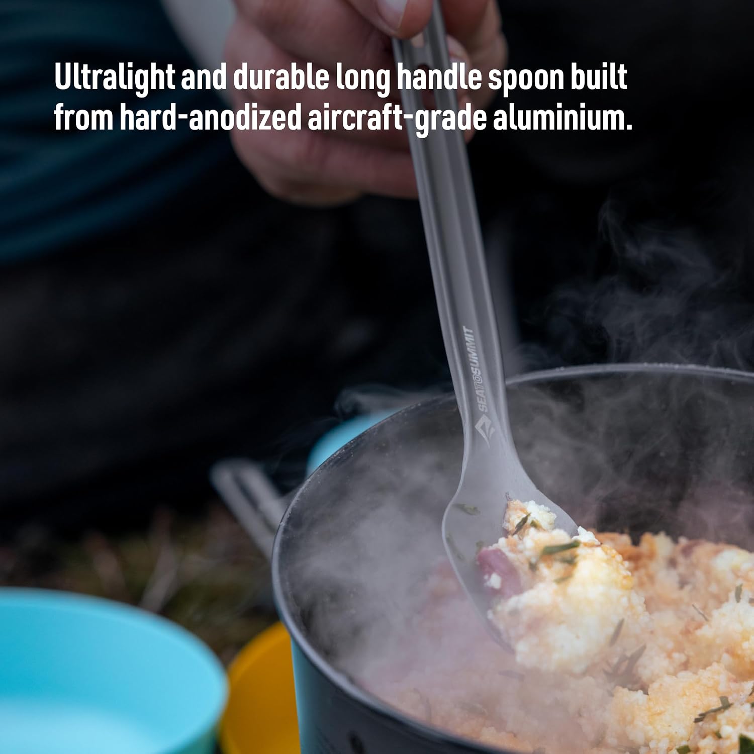 Sea to Summit Frontier long spoon lifting food from a steaming camp pot