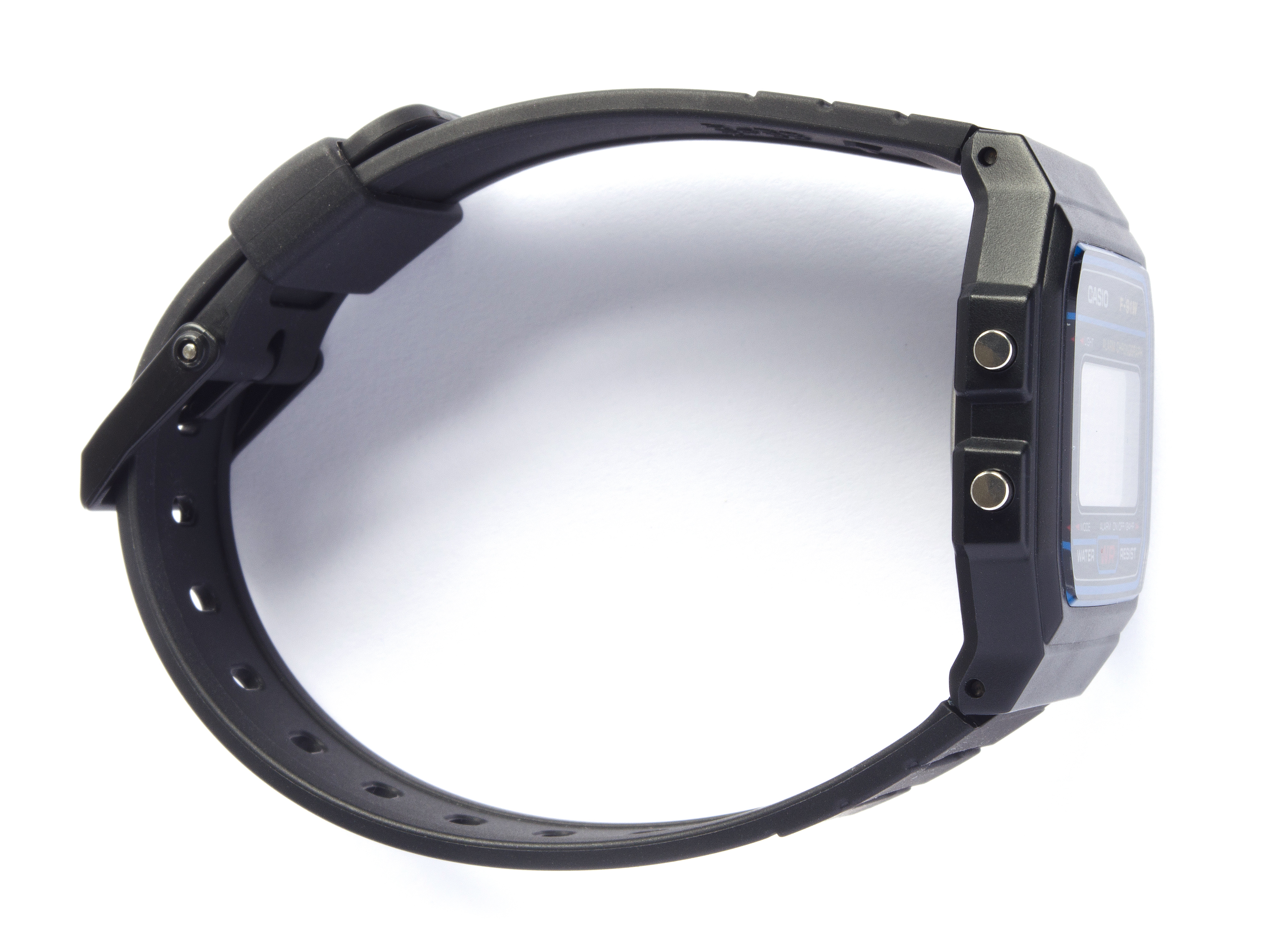 Side view of the black Casio F-91W case, two left-side buttons and buckled black strap