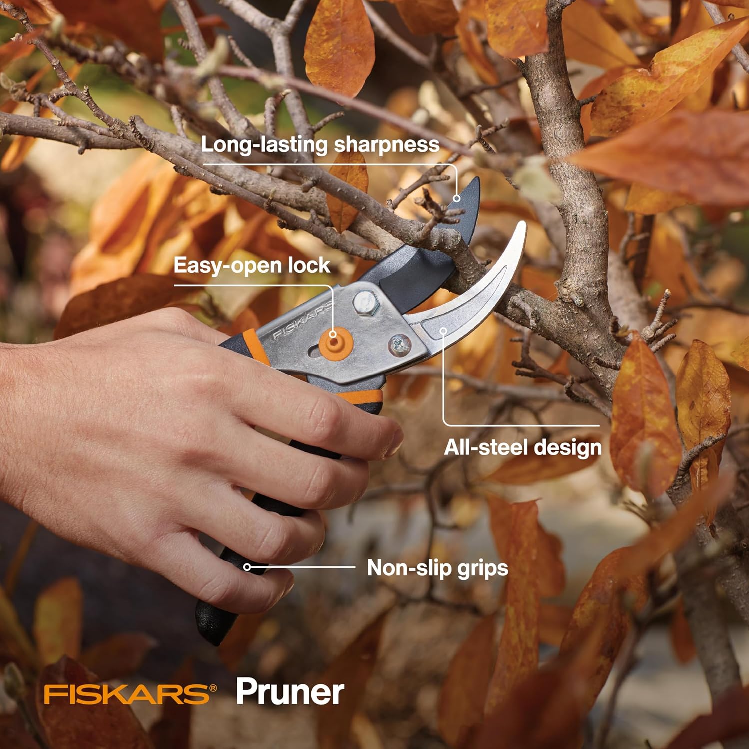 Fiskars traditional bypass pruner held at a branch in a source-gallery feature photograph.