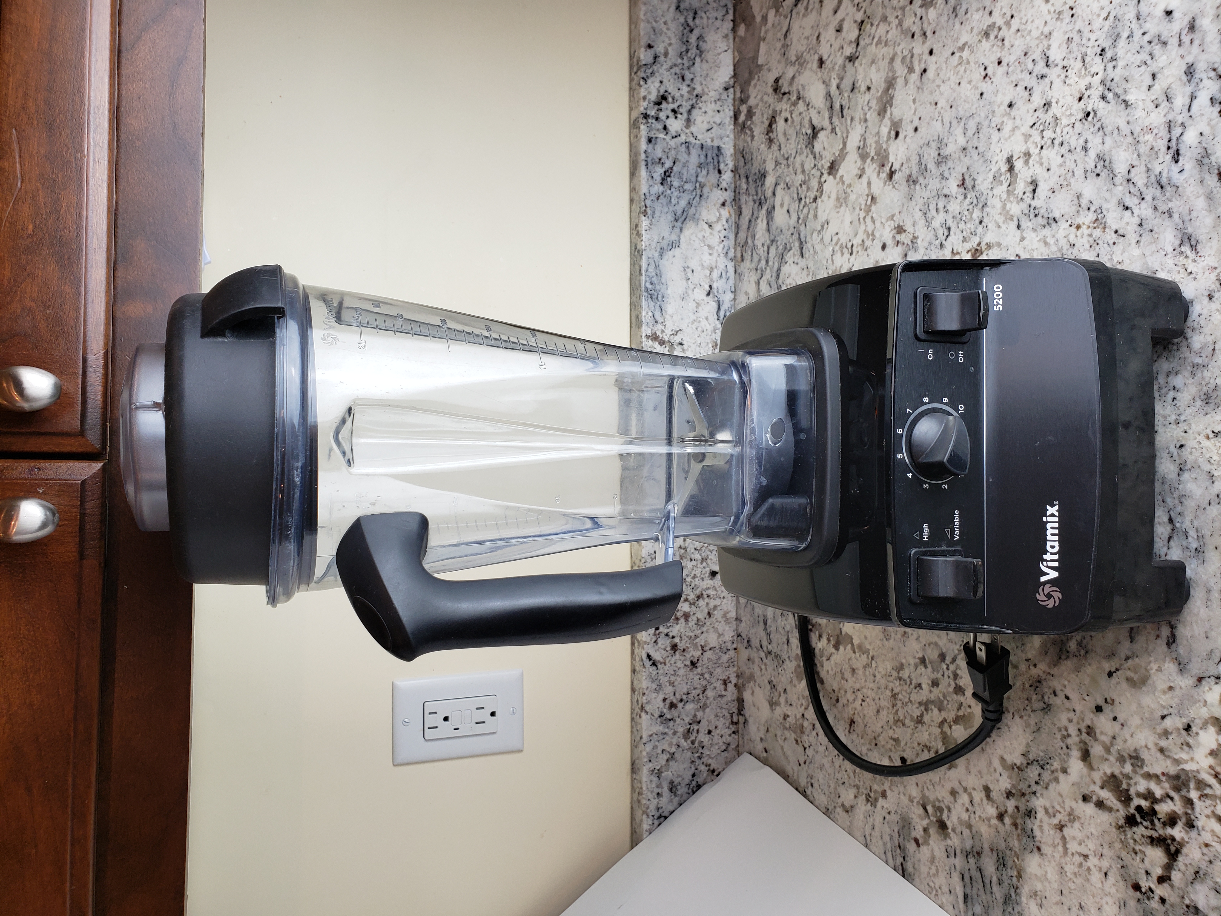 Black Vitamix 5200 blender with tall clear Classic container installed on the base.