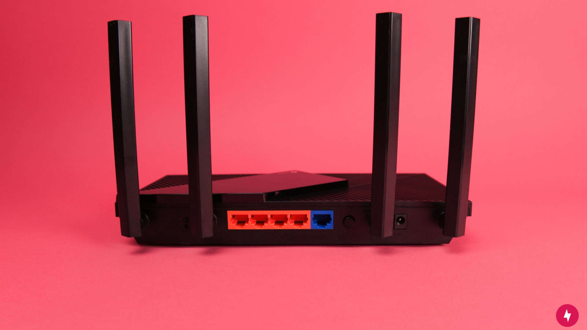 Rear view of TP-Link Archer AX21 V5 showing blue Gigabit WAN and four orange Gigabit LAN ports